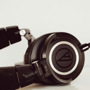 High-quality black studio headphones close-up, ideal for music and audio production environments.
